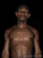 Pygmy boy in a rain forest village in the night