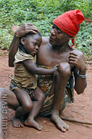 Pygmy grandmother with granddaughter in a rainforest camp
